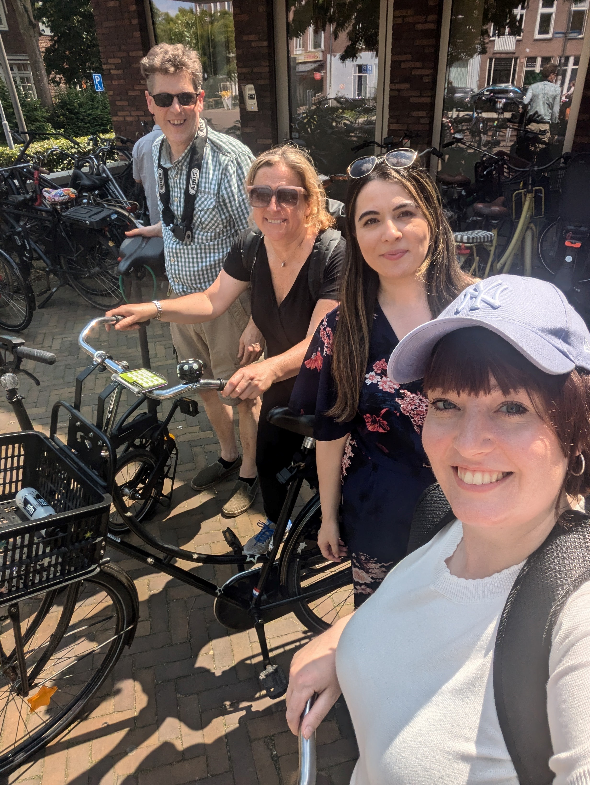 Lucy, Hattie, Aycan and Guus stand outside with bicycles